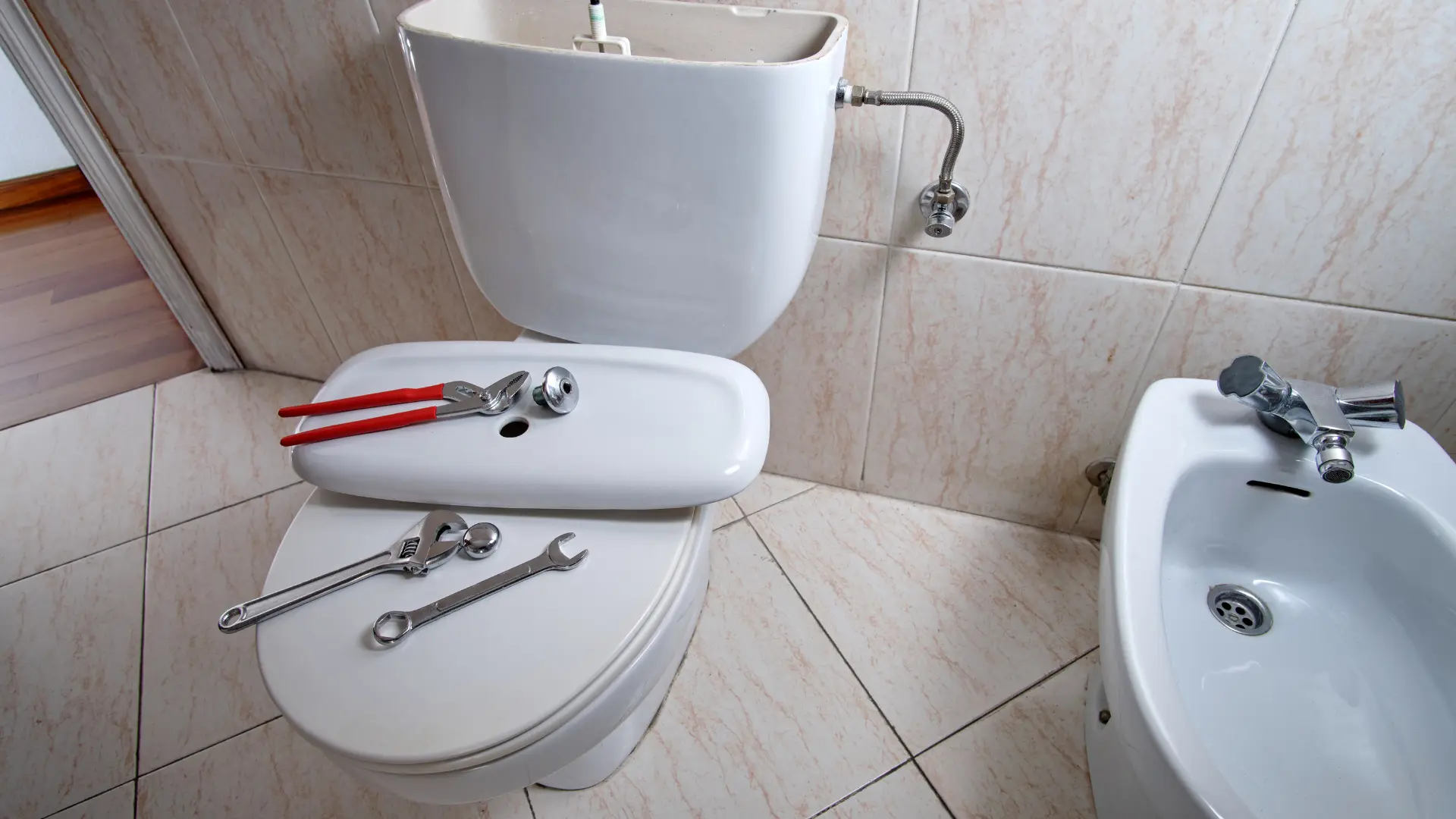Toilet cistern opened for repair with plumbing tools